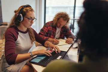 computer programmers working at coworking space in tech startup