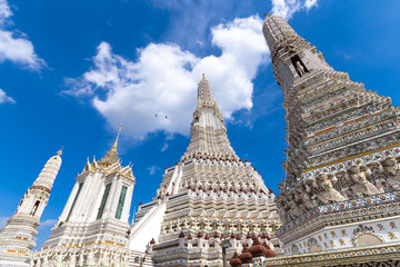 Wall Mural - The pagoda inside Wat Arun temple during beautiful blue sky with cloud in Bangkok, Thailand.