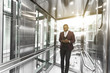 © xartproduction - successful and young businessman in the elevator business center rides to work