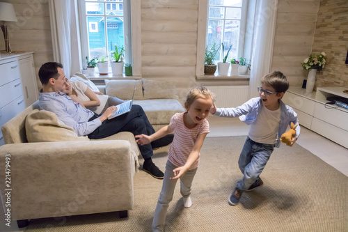 Happy Family Of Four Relaxing Spending Time At Home Together