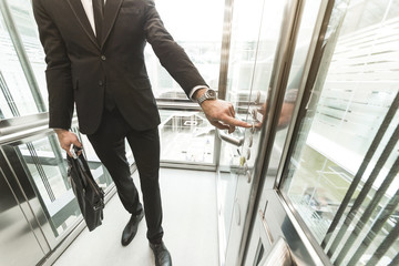 Man pressing elevator button. finger presses elevator button. businessman in lift