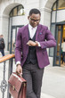 © xartproduction - stylish businesswoman with briefcase on city background. African American man talking on mobile phone
