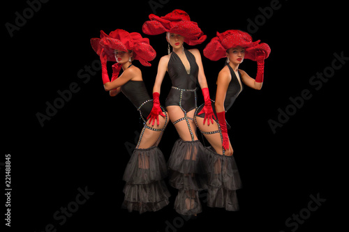 Cuadros en Lienzo Three beautiful cabaret dancers in red hats isolated on black