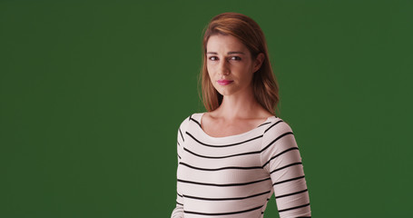 Poster - Attractive white woman standing looking at camera on green screen