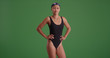 © rocketclips - Young female swimmer posing confidently on green screen