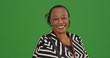 Happy older black woman poses for a portrait on green screen