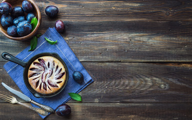 Wall Mural - Fresh homemade plum cake in iron skillet