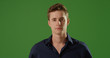 © Mark Adams - Handsome young Caucasian man looking at camera on green screen