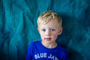 Wall Mural - portrait of a boy with blue background