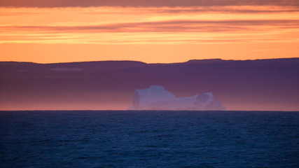 Wall Mural - orange sunset with iceberg in Greenland