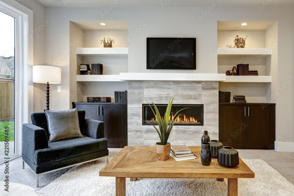 Obraz na płótnie Beautiful modern living room interior with stone wall and fireplace in luxury home w salonie