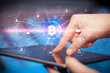 © ra2 studio - Hand using tablet with cryptocurrency bitcoin link network and online concept