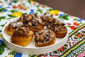 freshly baked buns with nuts on colored towel top view.