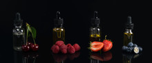 Four Flavor Flavors, In Glass Containers, On A Black Background, With A Taste Of Cherries, Strawberries, Raspberries, Blueberries, With Reflection