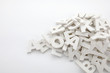 Pile of white painted wooden letters. Typography background composition.