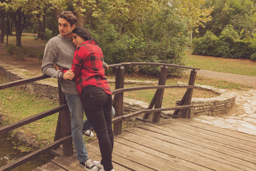 Wall Mural - Couple in love enjoying on the wooden bridge.