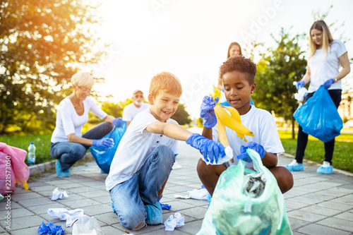 Fotografie, Obraz Volunteers with garbage bags cleaning up garbage outdoors - ecology concept
