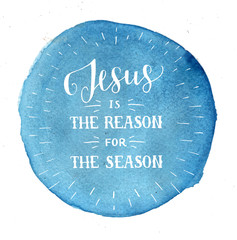 Hand lettering Jesus is the reason for season on blue watercolor background.