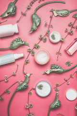 Wall Mural - beauty flat lay with various facial cosmetic products with mock up, leaves and green flowers on past