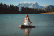 Woman meditation in mountain lake