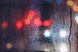 Rain drops on the window in the night city. Blurred background