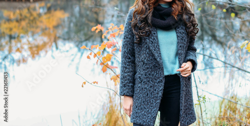 Fotografie, Tablou woman brown-haired woman in a gray coat, a blue sweater and a black scarf, snod