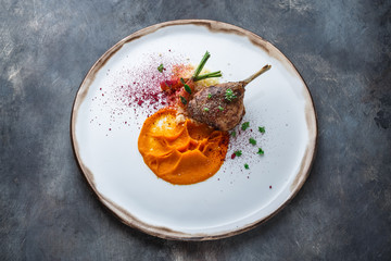 Duck leg confit with batat puree, carrots and couscous, restaurant meal