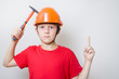© FOTO_STOCKER - Boy in helmet, hard hat with idea gesture. Young builder with hocked face knocks with hammer on head -construction, protection, life safety fundamentals, brainstorming and creativity concept.