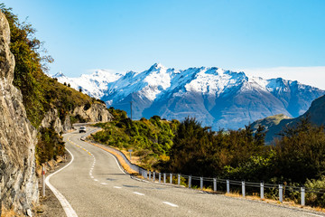 Stunning beautiful view of the road with alps mountain. Noon scenery with some cloudy and blue sky. nature scene in the countryside with green grassland and agriculture.