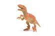 Plastic velociraptor toy isolated on white background