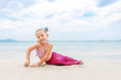© yarochkins - Little beautiful girl dressed in swimsuit as a mermaid sits on the seashore