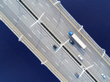 Aerial View Of Highway In The Ocean. Cars Crossing Bridge Interchange Overpass. Highway Interchange With Traffic. Aerial Bird's Eye Highway. Expressway. Road Junction. Car Passing. Bridge With Traffic