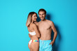 © New Africa - Happy young couple in beachwear on color background