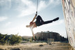 © Rendara Studio - Dancer performing aerial dance on urban scenery at sunset