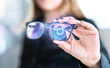 © terovesalainen - Virtual screen smart glasses with futuristic high tech interface. Woman holding spectacles with nanotech interface. Augmented reality vision with modern eyewear. Future innovation with IOT and VR.