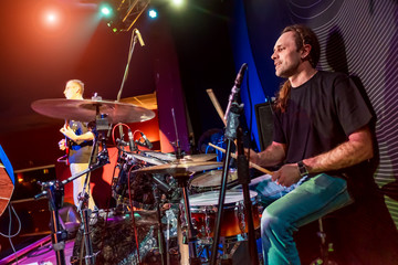 Wall Mural - Drummer playing on drum set on stage.