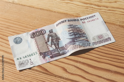 Fotografering A 500 Russian Ruble banknote on a wooden table top