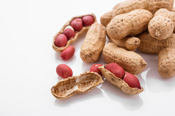 Wall Mural - fresh peanuts on a white acrylic background