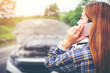 © joyfotoliakid - Young Woman calling for assistance with his car broken down by the roadside