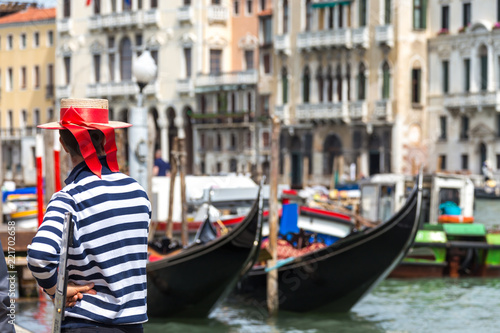 Fotografie, Obraz Gondolier standing next to gondola waiting for a client
