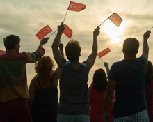 Back View People Raising Turkish Flags. Family Silhouette Against Sunset Background.