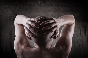 Young man grabbing his head with his hands