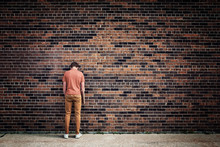 Student Blending Into Brick Wall