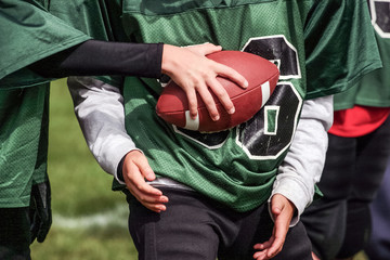 Football hand off in youth football game