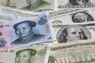 Chinese yuan and American dollars as a background