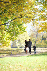 Wall Mural - Family with children in autumn park