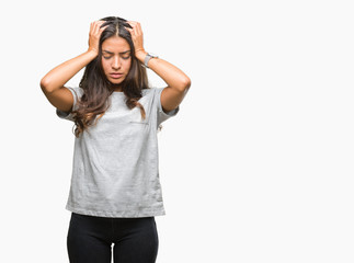 Wall Mural - Young beautiful arab woman over isolated background suffering from headache desperate and stressed because pain and migraine. Hands on head.