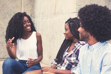 Beautiful african american woman talking with couple from Africa