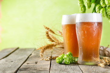 Canvas Print - Beer and ingredients hops, wheat, barley on wood background, copy space