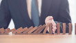 © oatawa - Problem Solving, Close up hand of businessman stopping falling blocks on table.